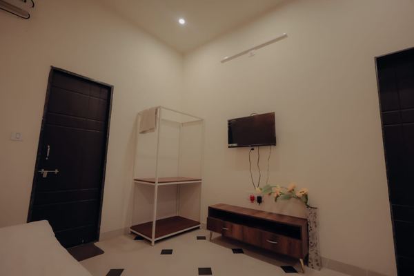 Bedroom corner with TV and wardrobe