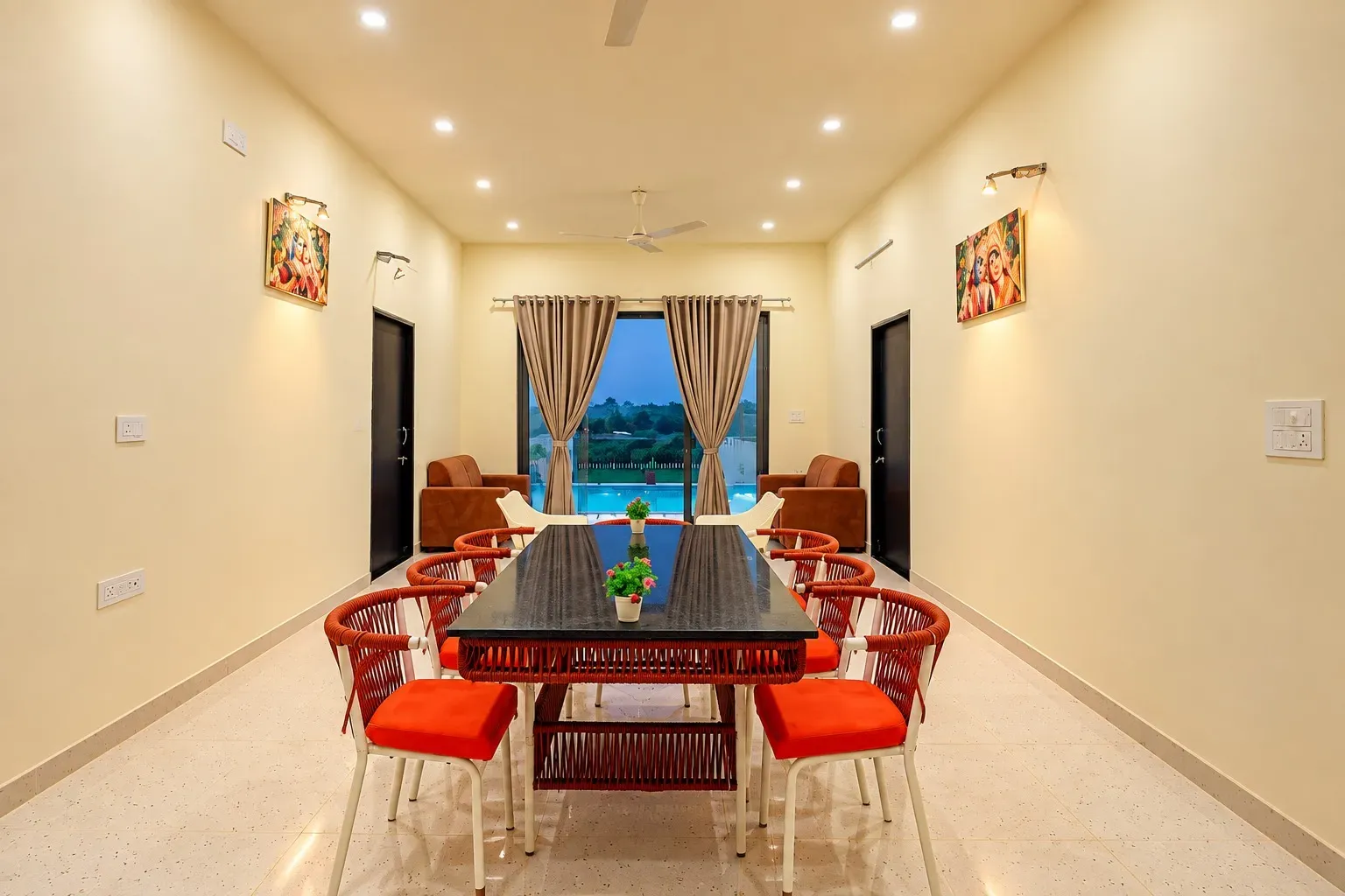 Luxury villa in Udaipur showcasing a modern dining room overlooking the private pool