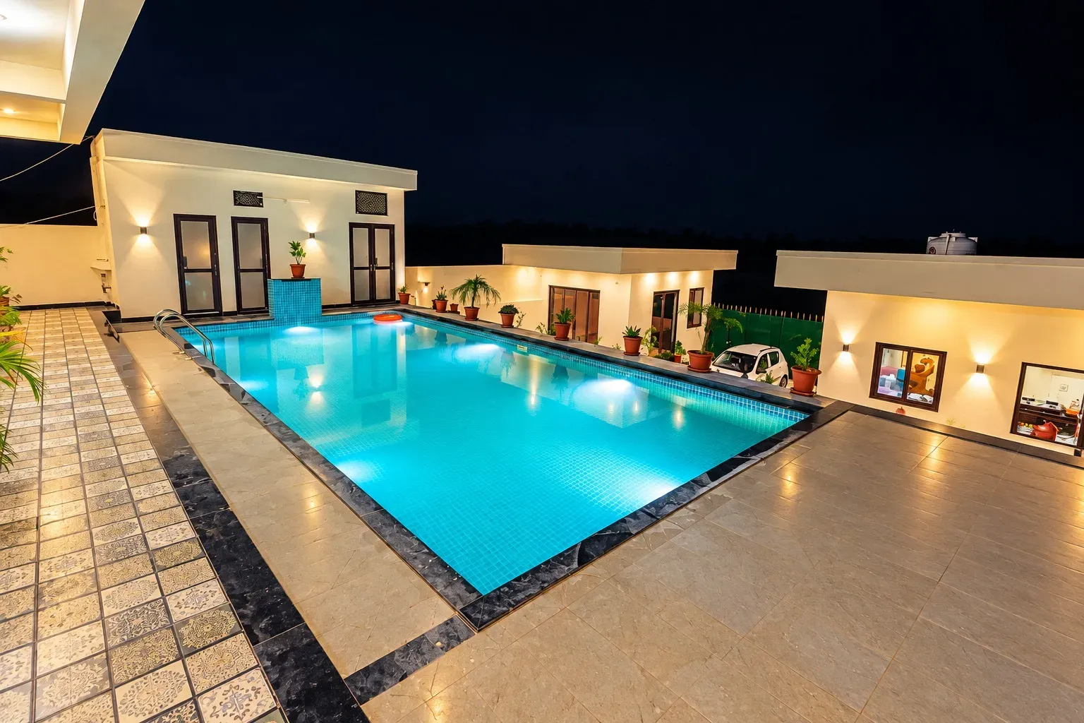 Villa with private pool in Udaipur showcasing a spacious pool and modern outdoor terrace